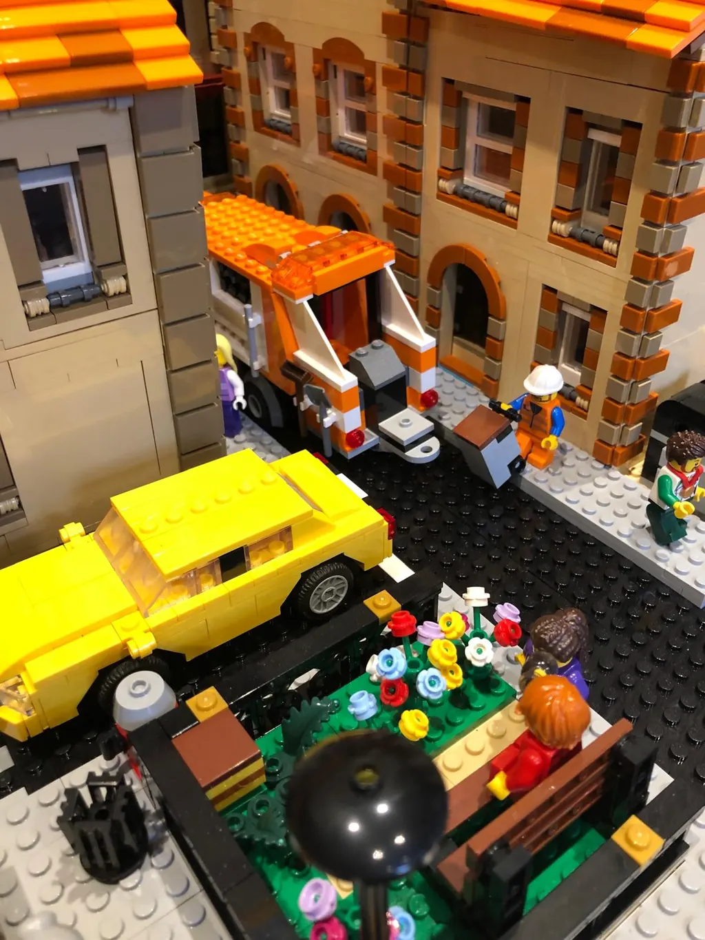 Brick high street with cars and passers-by