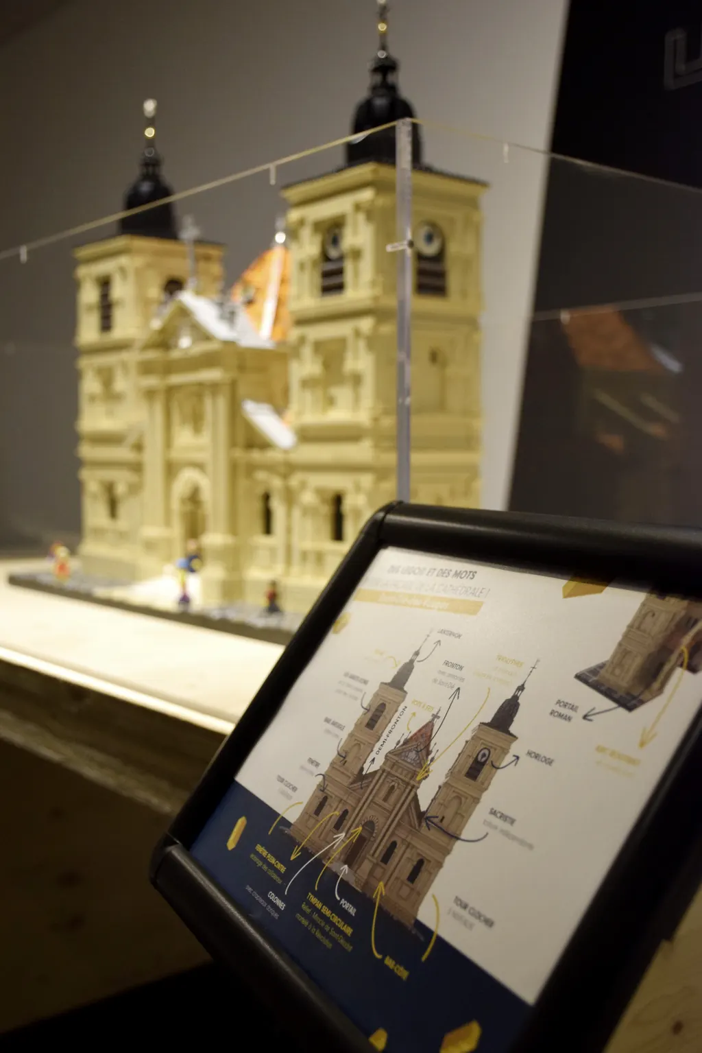 The cathedral plan shown on a tablet beside the model